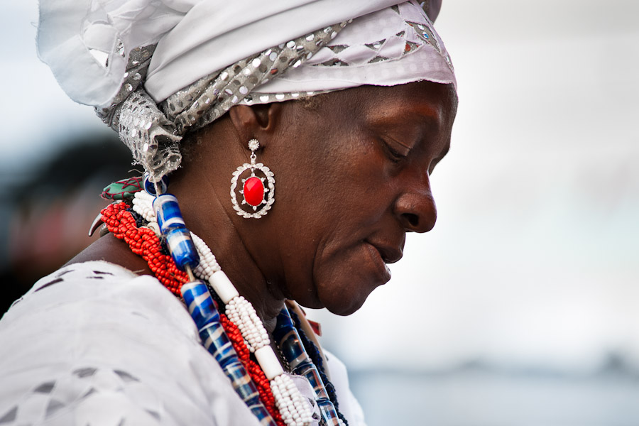A Baiana woman, performing a spiritual cleansing ritual, seen in front of the St. Lazarus church in Salvador, Bahia, Brazil.