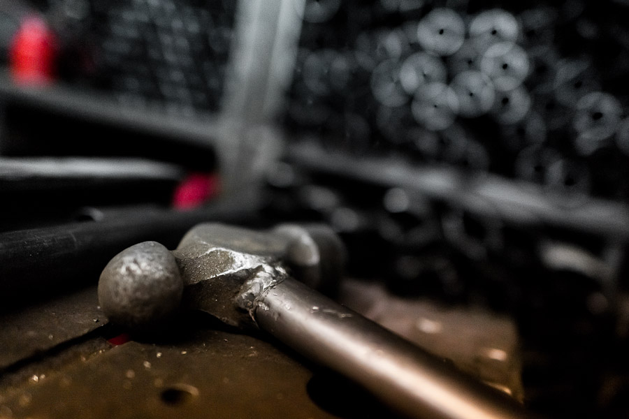 A ball-peen hammer lies on the workbench in a small scale bicycle factory in Bogota, Colombia.