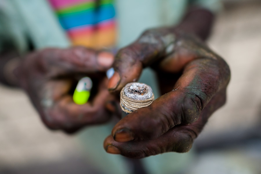 A hand of a Colombian drug user, holding a pipe loaded with ‘bazuco’ (a raw cocaine paste), is seen on the street of ‘Bronx’, in Medellín, Colombia.