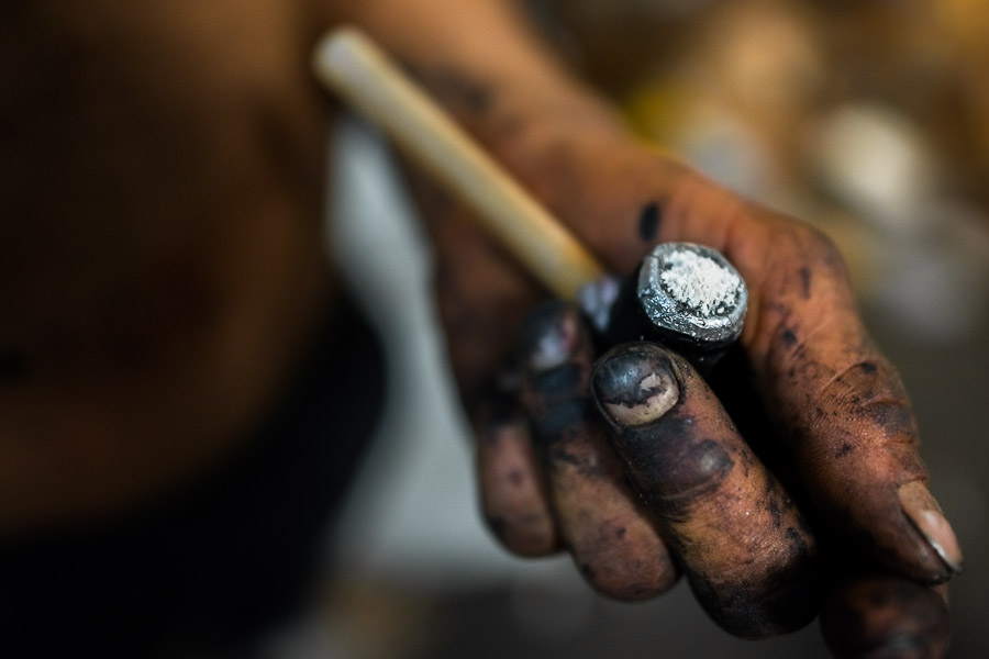 A hand of a Colombian drug user, holding a pipe loaded with ‘bazuco’ (a raw cocaine paste), is seen on the street of ‘Bronx’, in Medellín, Colombia.