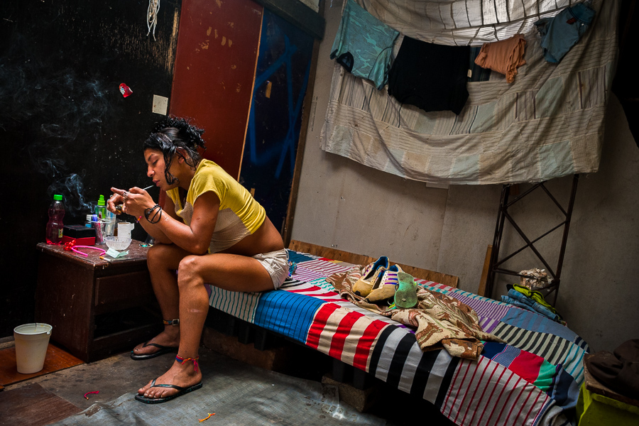 A young Colombian drug addict is seen during consumption of a raw cocaine paste while sitting in a basic room in Medellín, Colombia.