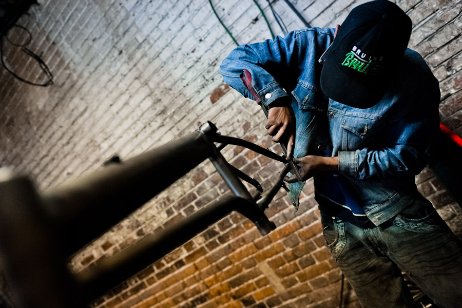 A bicycle worker grinds a recently welded bike frame in a small scale bicycle factory in Bogota, Colombia.