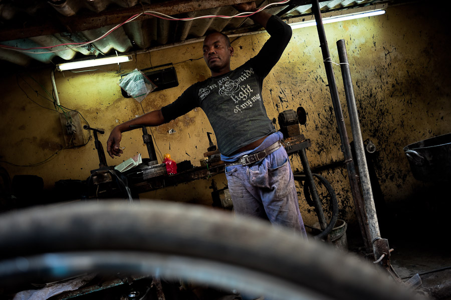 A Cuban service man in the bicycle repair shop, Havana, Cuba.