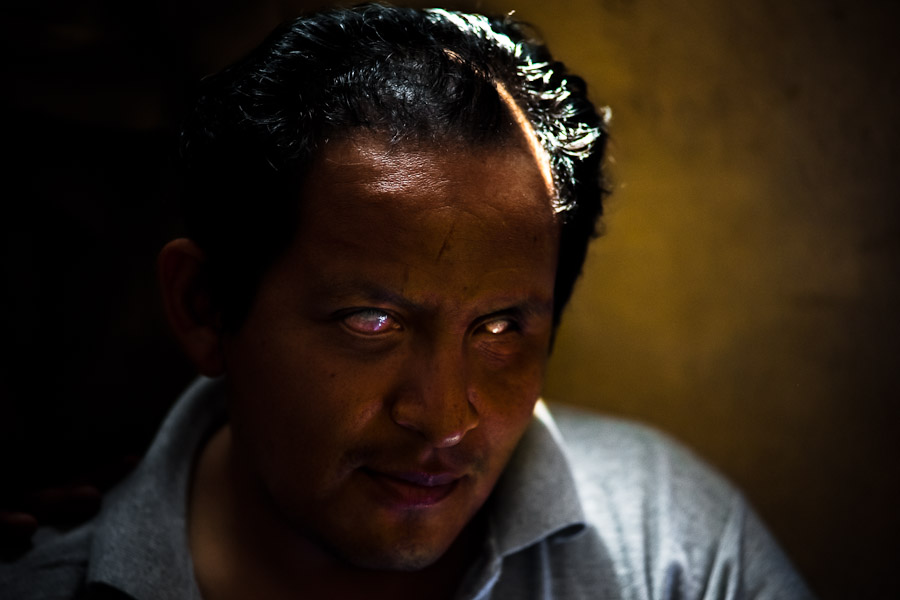 A blind man relaxes in the changing room of Unión Nacional de Ciegos del Perú, a social club for the visually impaired in Lima, Peru.