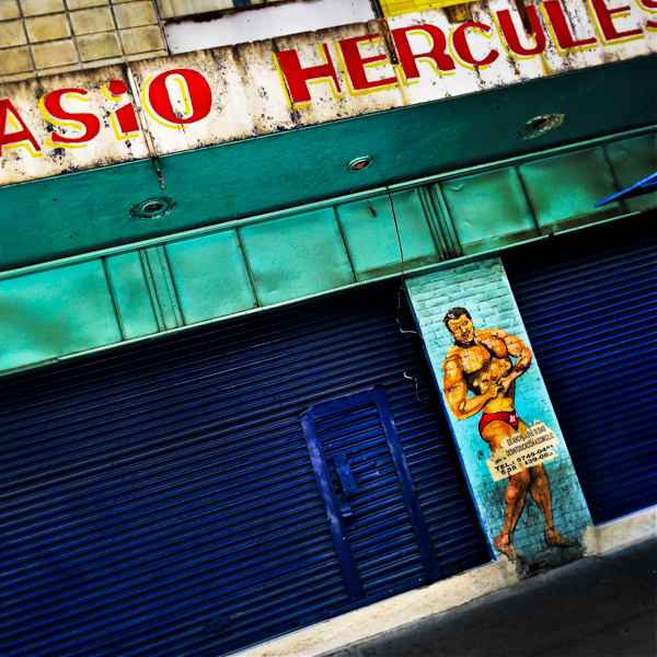 A painted artwork, depicting a bodybuilding athlete and serving as a public advertisement for a gym, is seen on the street in Buenavista, a neighborhood in Mexico City, Mexico.