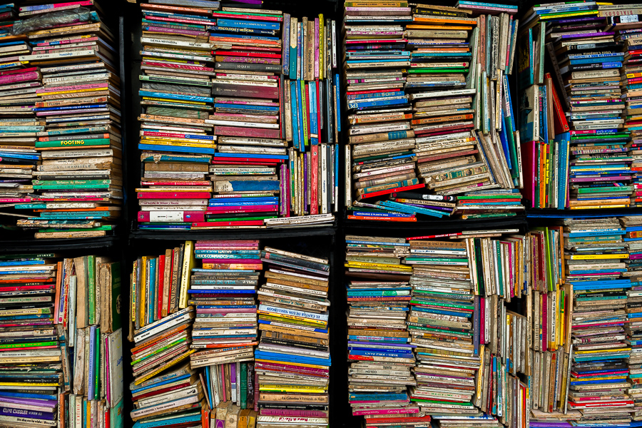 Used books are seen stacked in boxes on the street in a secondhand bookshop in San Salvador, El Salvador.