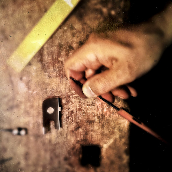 Jan Madiara, a master bow-maker, mounts a bow frog on a bow stick in his workshop in Karlovy Vary, Czech Republic.