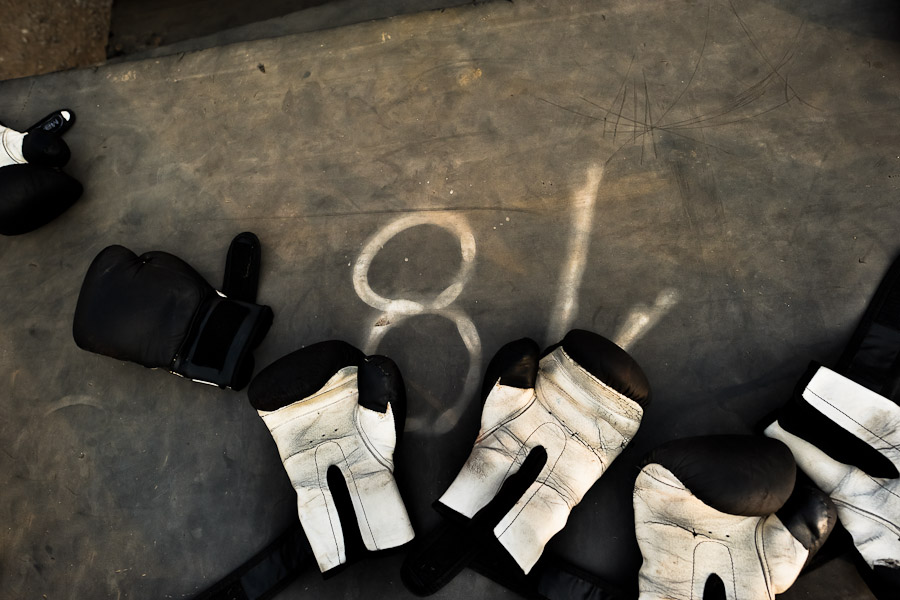 Shared boxing gloves seen at the Boxeo VMT boxing club in an outdoor gym in Lima.