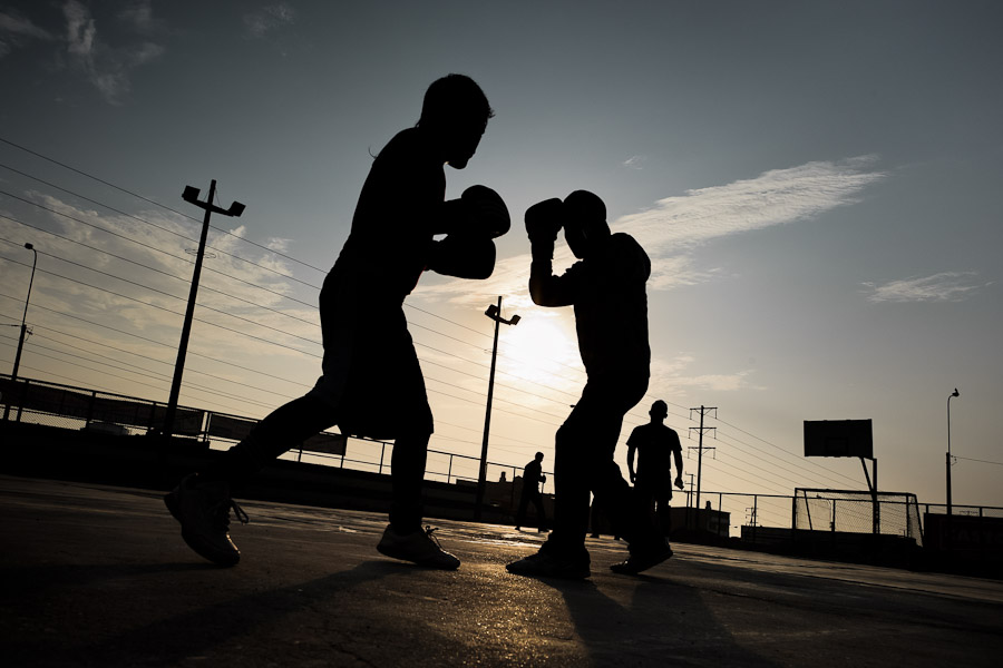 Peruvian youths workout at a sparring session at the Boxeo VMT boxing club in an outdoor gym in Lima.