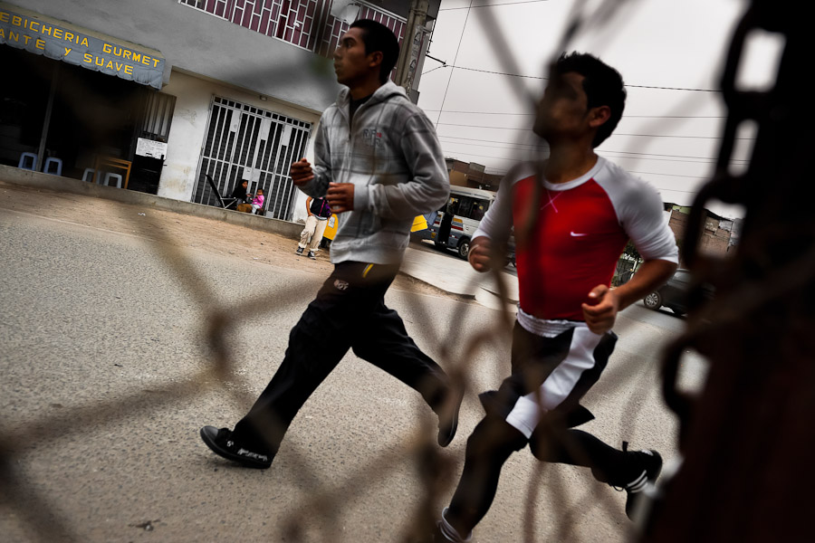 Peruvian youths run around a playground at the Boxeo VMT boxing club in an outdoor gym in Lima, Peru.