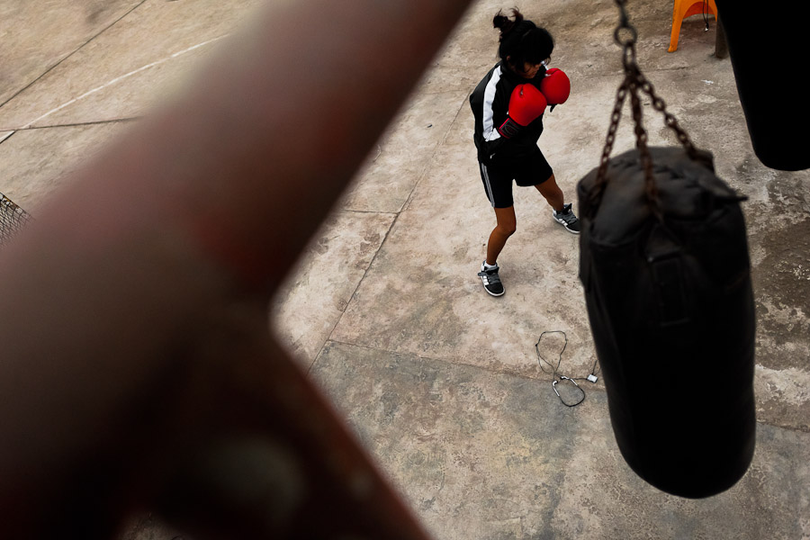 A young Peruvian girl practices with a punching bag at the Boxeo VMT boxing club in an outdoor gym in Lima, Peru.