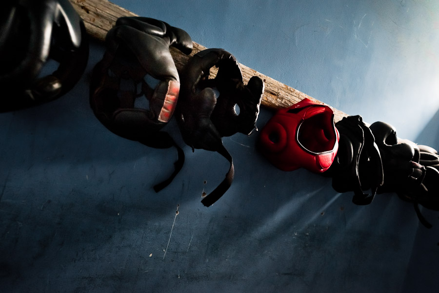 Boxing headgear hung on the rack in the boxing changing room of the Boxeo VMT boxing club in an outdoor gym in Lima, Peru.