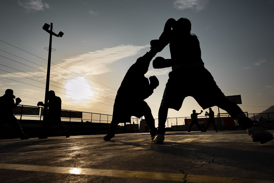 Peruvian youths practice boxing sparring at the Boxeo VMT boxing club in an outdoor gym in Lima.