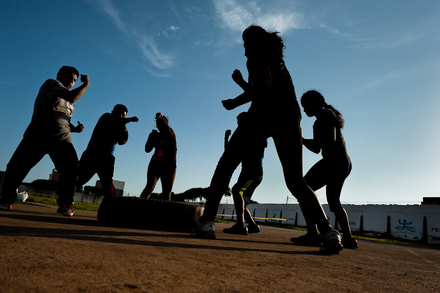 Peruvian youths practice shadowboxing while training in the outdoor boxing school at the Telmo Carbajo stadium in Callao, Peru.