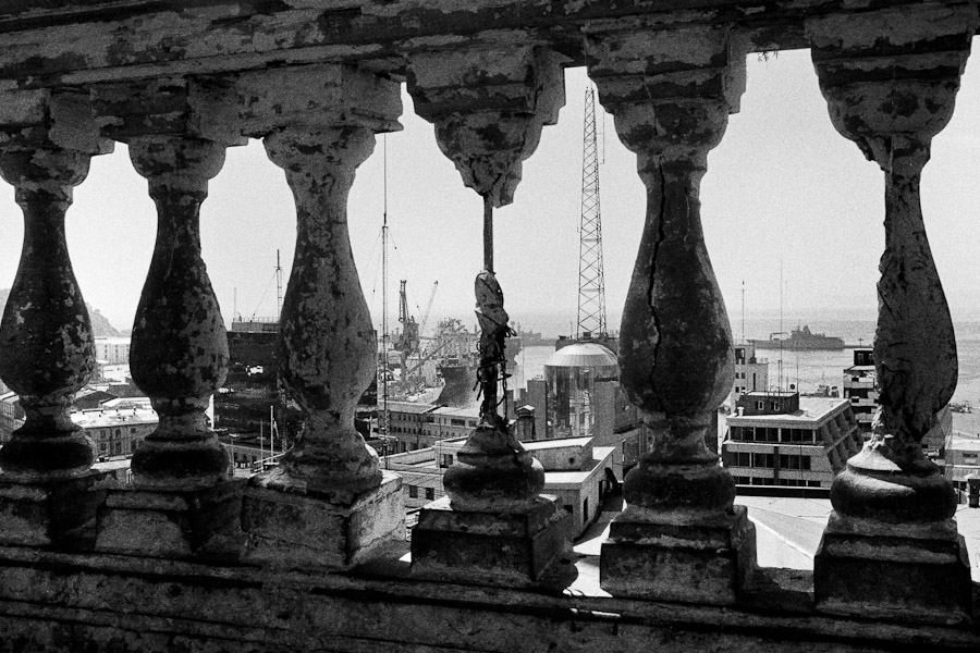 A view of the port seen through a broken balustrade built on a hill in Valparaíso, Chile.