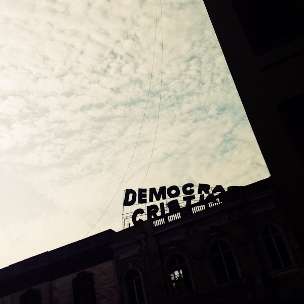 Falling letters of a broken neon sign are seen on the roof of a colonial house in the center of Lima, Peru.