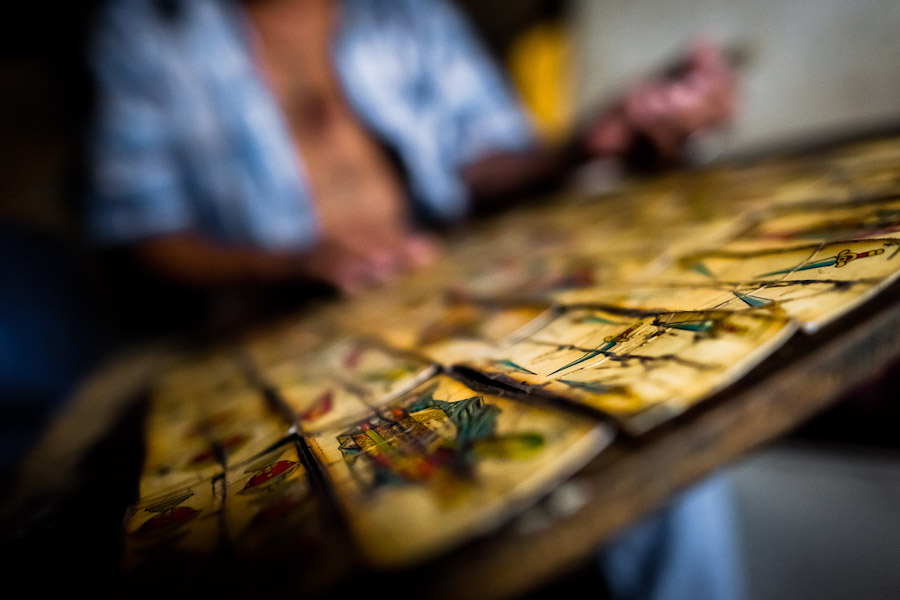 A Colombian urban shaman (brujo) reads playing cards to devine the future for the client in his house in Cali, Colombia.