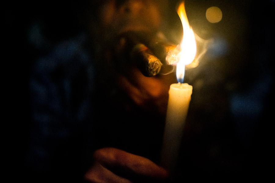 A Colombian urban shaman (brujo) devines the future from burn tobacco leaves in his house in Cali, Colombia.