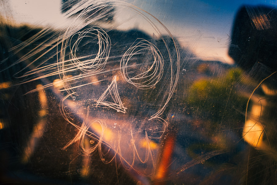 A skull tag is seen scratched into the glass window of a subway car passing in the outskirts of Mexico City, Mexico.