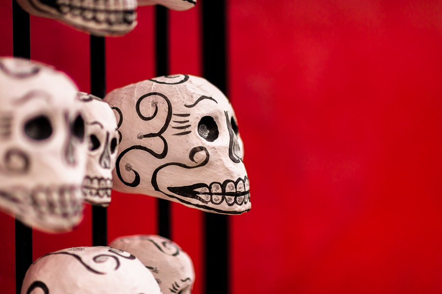 Hand-painted skulls (Calaveras) are seen placed on a street door during the Day of the Dead celebrations in Oaxaca, Mexico.