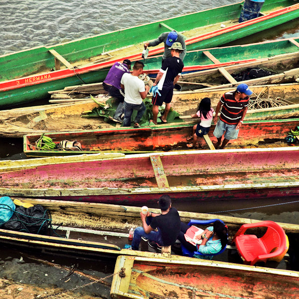 Panamanian villagers sell fish and bananas inside the canoes anchored on the riverside in El Real de Santa María, Darién, Panama.