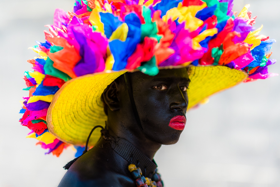 A young Afro-Colombian man, a member of the folkloric group Son de Negro, prepares himself for the parade of the Carnival in Barranquilla, Colombia.