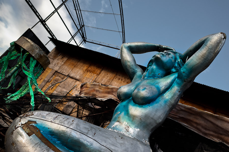 A damaged carnival statue of a mermaid abandoned on the work yard behind the Samba school workshops in Rio de Janeiro, Brazil.