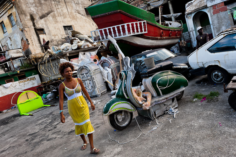 A Brazilian woman walks among the discarded carnival statues on the work yard behind the Samba school workshops in Rio de Janeiro, Brazil.