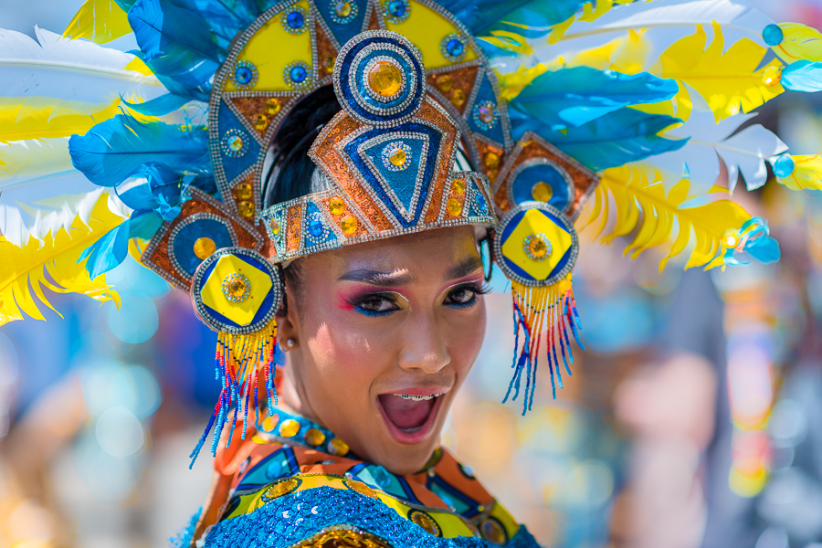 A Colombian dancer, wearing a feathered headband, performs excitedly during the Batalla de Flores, the major parade of the Carnival in Barranquilla, Colombia.