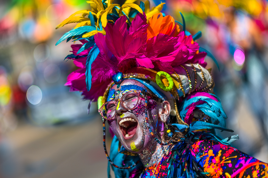 A Colombian woman, wearing a feathered costume, excitedly performs in the Batalla de Flores, the major parade of the Carnival in Barranquilla, Colombia.