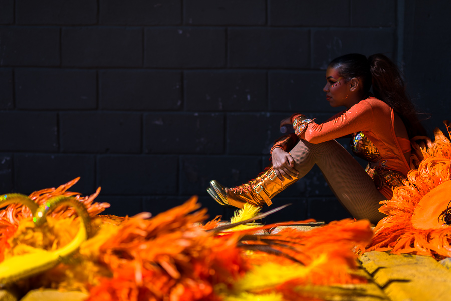 A Colombian dancer waits in the shadow for the start of the Batalla de Flores, the major parade of the Carnival in Barranquilla, Colombia.