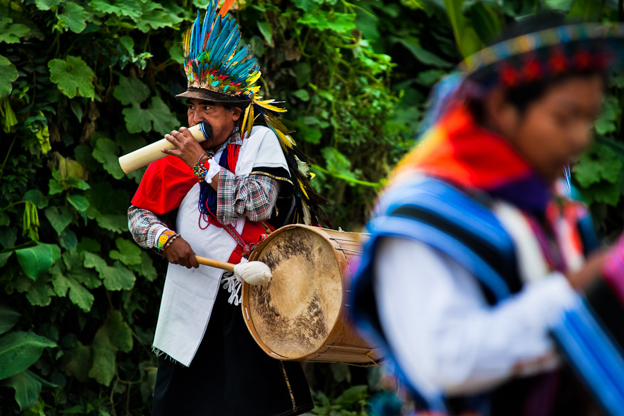 A native from the Kamentsá tribe, wearing a colorful feather headgear, plays drum during the Carnival of Forgiveness, a traditional indigenous celebration in Sibundoy, Colombia.