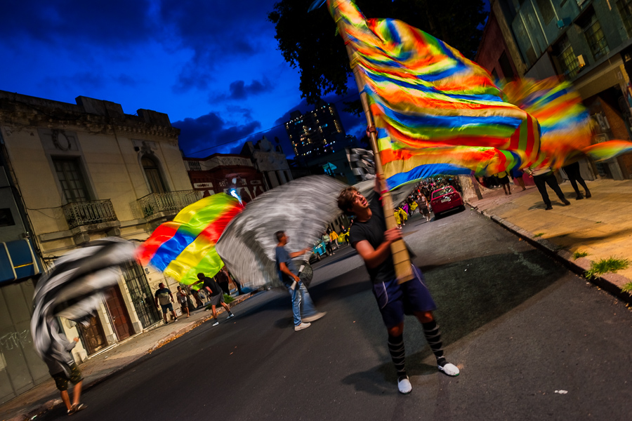 Flag bearers (the Portabanderas) wave giant flags as they perform during a rehearsal for Carnival in Montevideo, Uruguay.