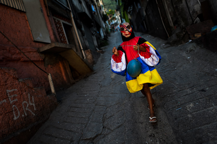 A Brazilian boy, wearing a spooky costume, takes part in the Carnival parade in the favela of Rocinha, Rio de Janeiro, Brazil.