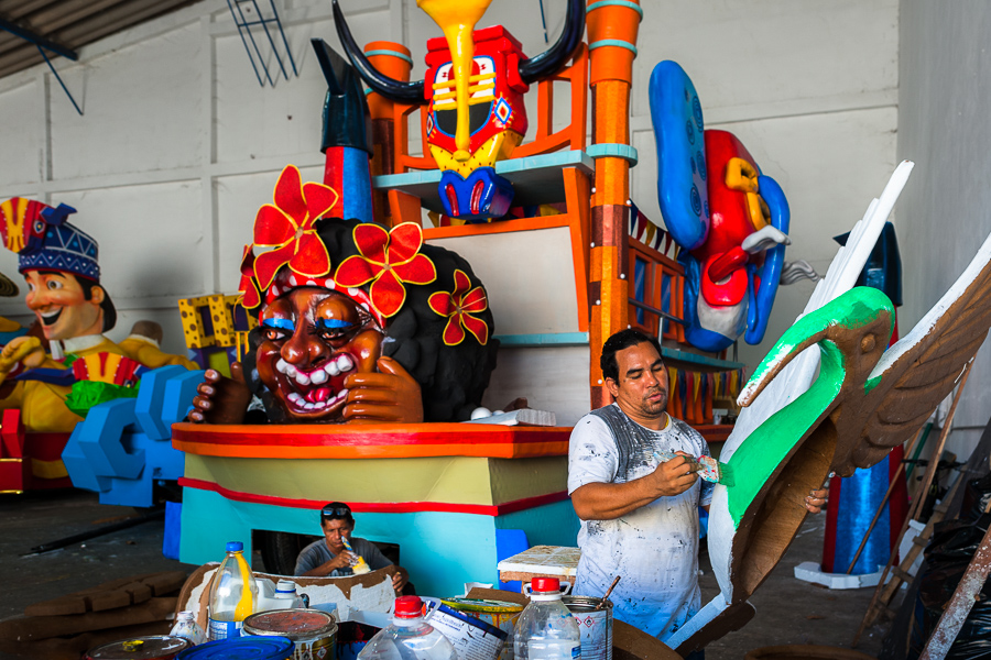 Colombian artisans paint paper-mâché sculptures for an allegorical float at the Carnival float workshop in Barranquilla, Colombia.