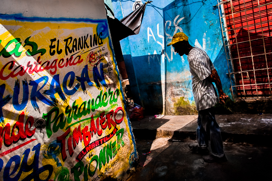 A Colombian man walks around the wall covered by Champeta graffiti art in the Bazurto market in Cartagena, Colombia.
