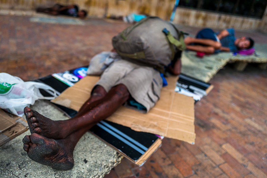 Afro-Colombian homeless men sleep on the cardboard in the historical center of Cartagena, Colombia.