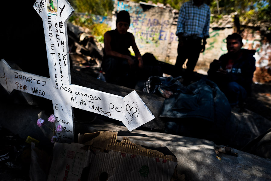 Central American immigrants wait near the railroad track to climb up the cargo train passing through Lechería station, Mexico City, Mexico.