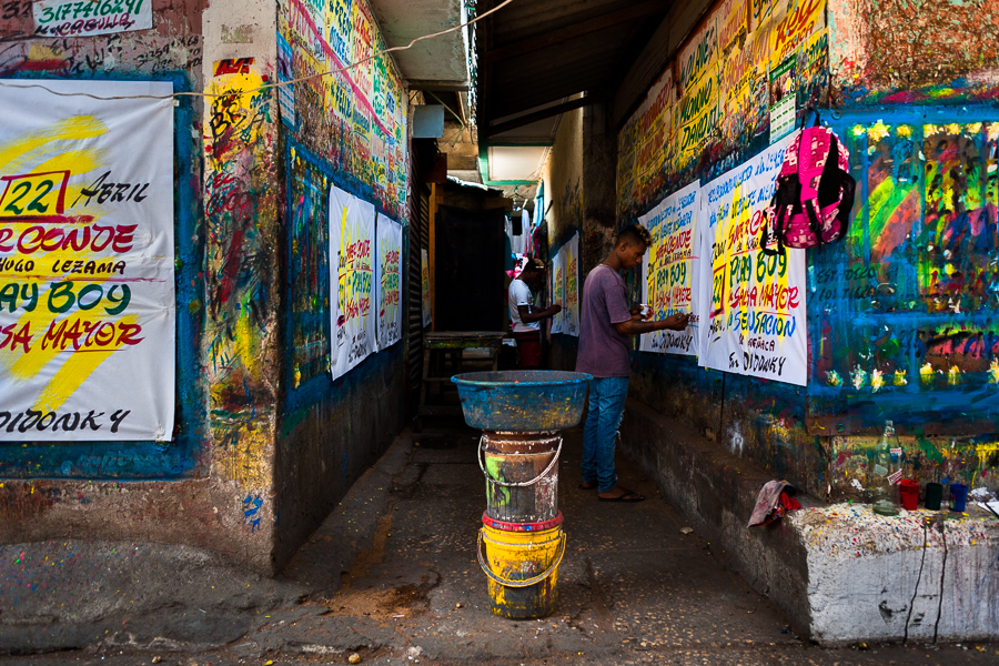 Colombian sign painters write with a brush while working on music party posters in the sign painting workshop in Cartagena, Colombia.