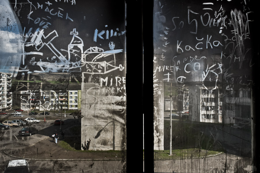 A view through the dirty window shows the Gipsy ghetto in Chanov, Czech Republic.