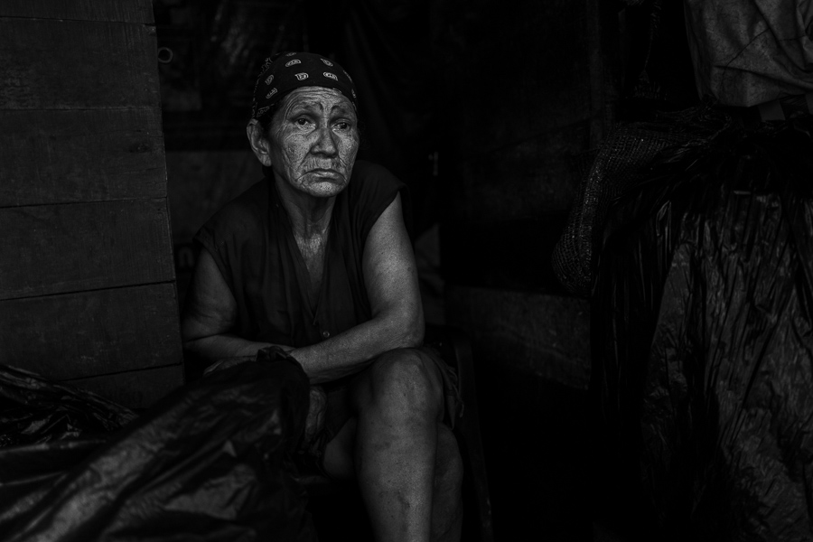 A Colombian charcoal worker waits for customers in her small charcoal retail shop in a street market in Barranquilla, Colombia.