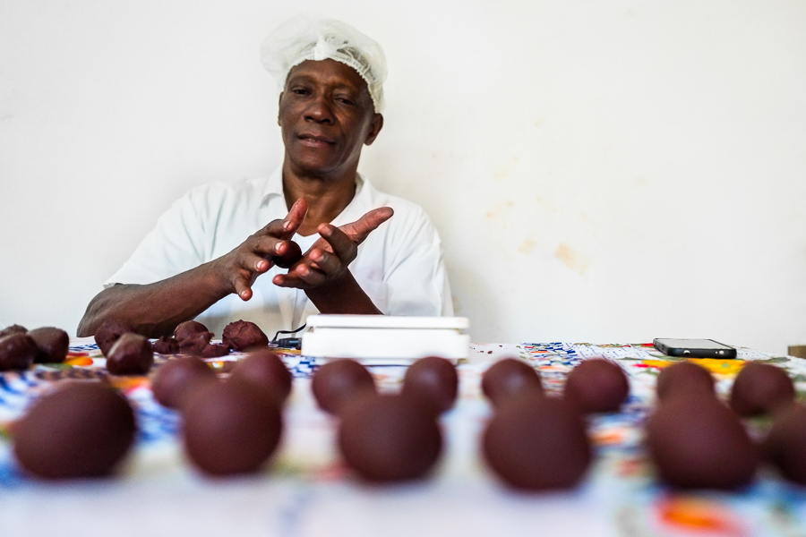 Rigoberto Balanta, an Afro-Colombian farmer, rolls the raw cacao paste with hands into balls, used for hot chocolate preparation, in artisanal chocolate manufacture in Cuernavaca, Cauca, Colombia.