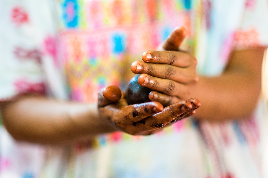 An indigenous woman rolls the raw cacao paste with hands into balls in artisanal chocolate manufacture in Guerrero, Mexico.