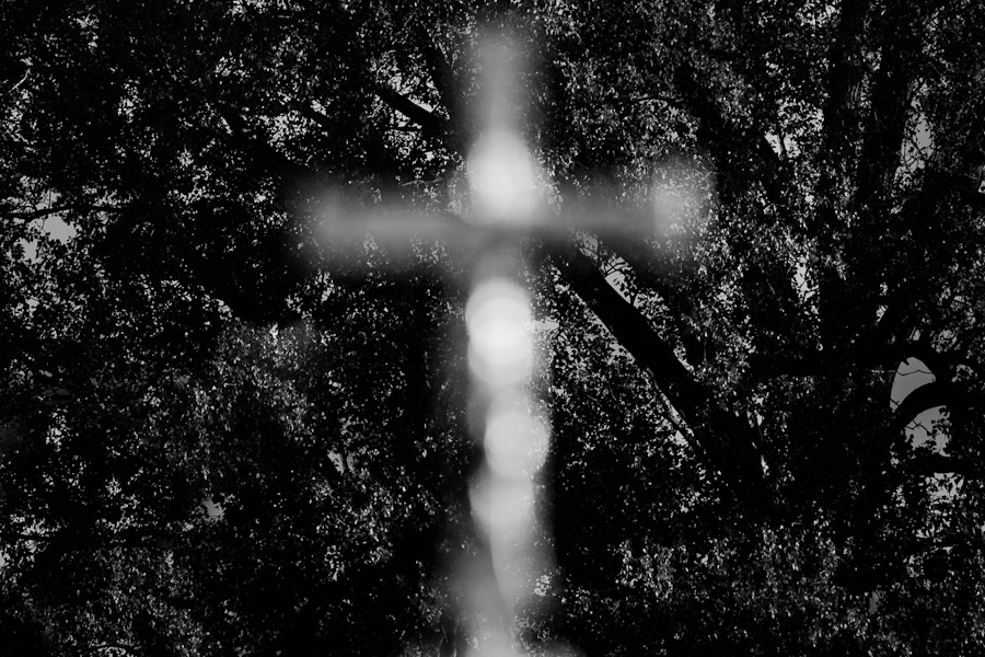 A Christian symbol of cross seen against a background of trees upon the outdoor mass served by the Pope Benedict XVI in Stara Boleslav.