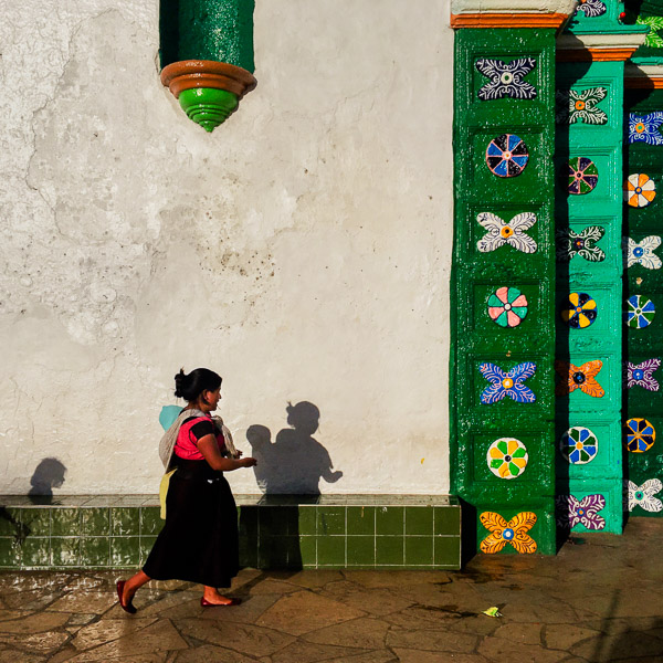 An indigenous Maya woman walks in front of the church of San Juan Bautista in San Juan Chamula, Chiapas.