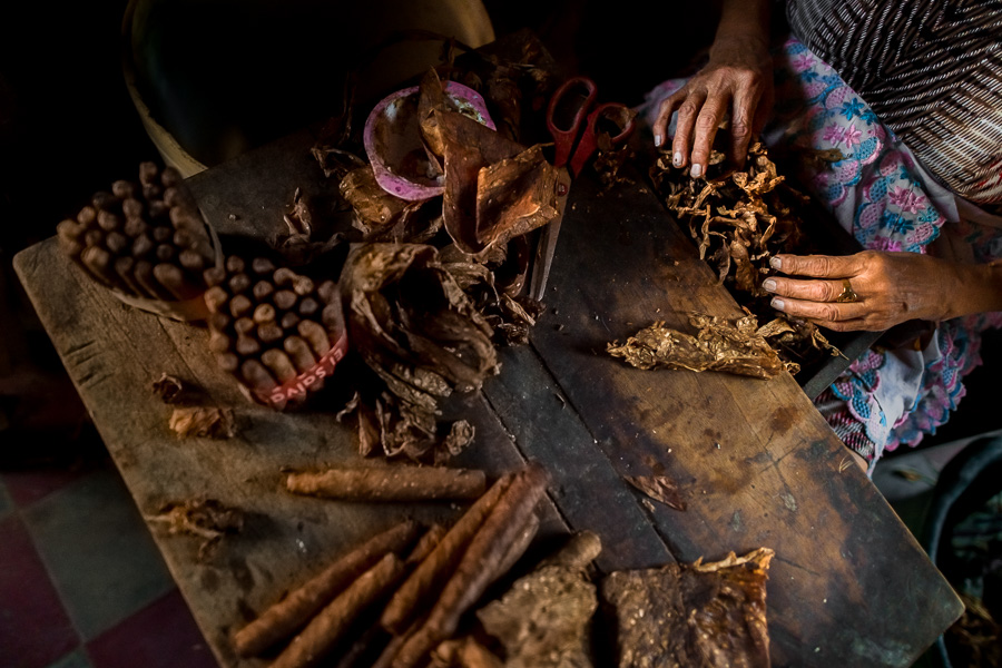 Laura Peña, a 67-years-old Salvadoran woman, selects tobacco leaves to make handmade cigars in her house in Suchitoto, El Salvador.