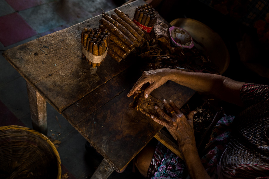 Laura Peña, a 67-years-old Salvadoran woman, rolls tobacco leaves into a handmade cigar in her house in Suchitoto, El Salvador.