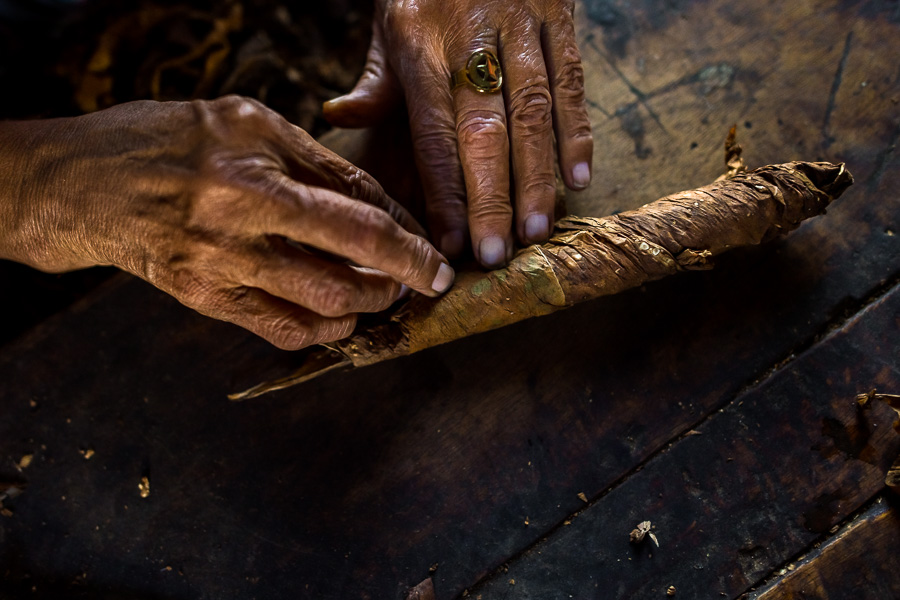 Hands of Laura Peña, a 67-years-old Salvadoran woman, are seen while rolling tobacco leaves to make handmade cigars in Suchitoto, El Salvador.