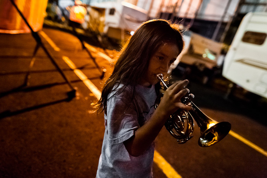 A young boy, a member of the old circus family Fuentes Gasca from Mexico, plays trumpet in the backstage of Circo de Renato, in San Salvador, El Salvador.