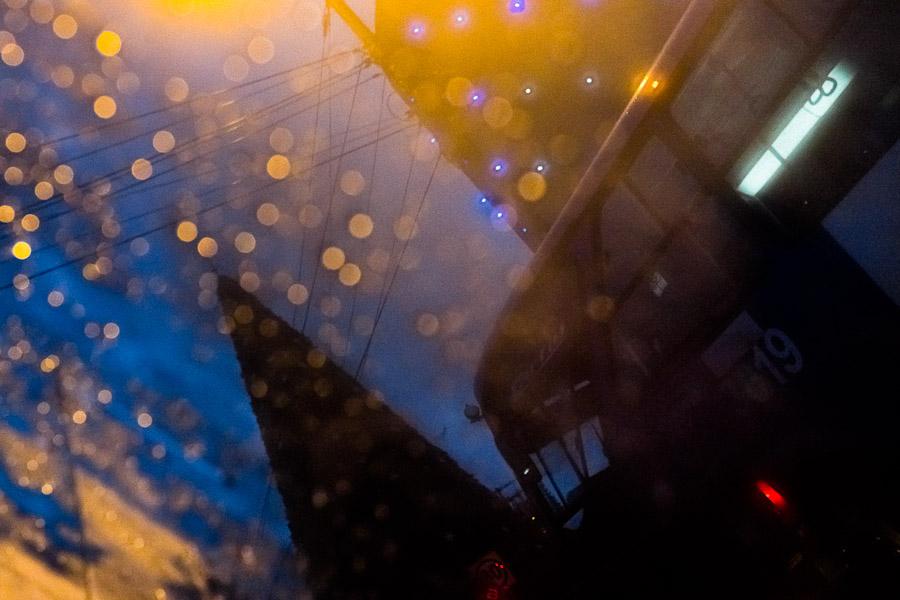 A traffic jam seen through a rainy car window during the twilight in Quito, Ecuador.